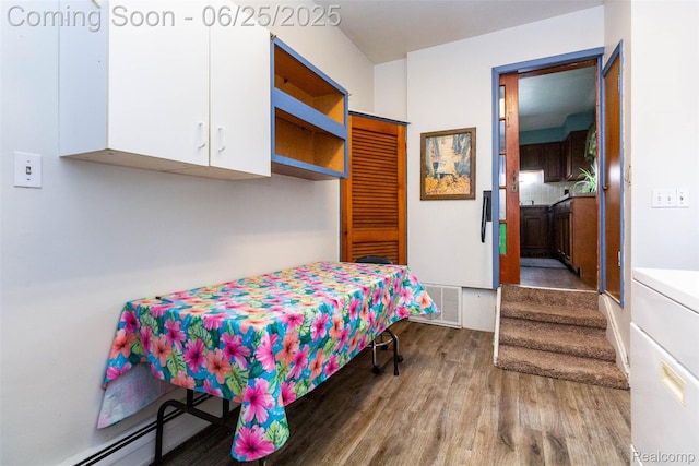 4144 Hillcrest Dr, Warren, MI 48092 - bedroom featuring wood finished floors and a baseboard heating unit