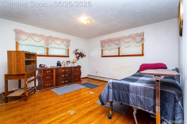 4144 Hillcrest Dr, Warren, MI 48092 - bedroom with wood finished floors, a baseboard radiator, and a textured ceiling