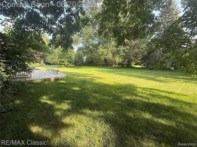 3417 Ramada Dr, Highland, MI 48356 - view of green lawn with a deck