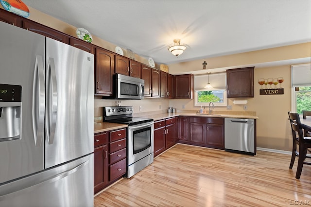 3564 Sapphire Dr, Adrian, MI 49221 - kitchen featuring stainless steel appliances, light countertops, and light wood-type flooring