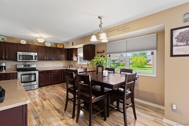 3564 Sapphire Dr, Adrian, MI 49221 - dining room featuring light wood-style flooring and a chandelier