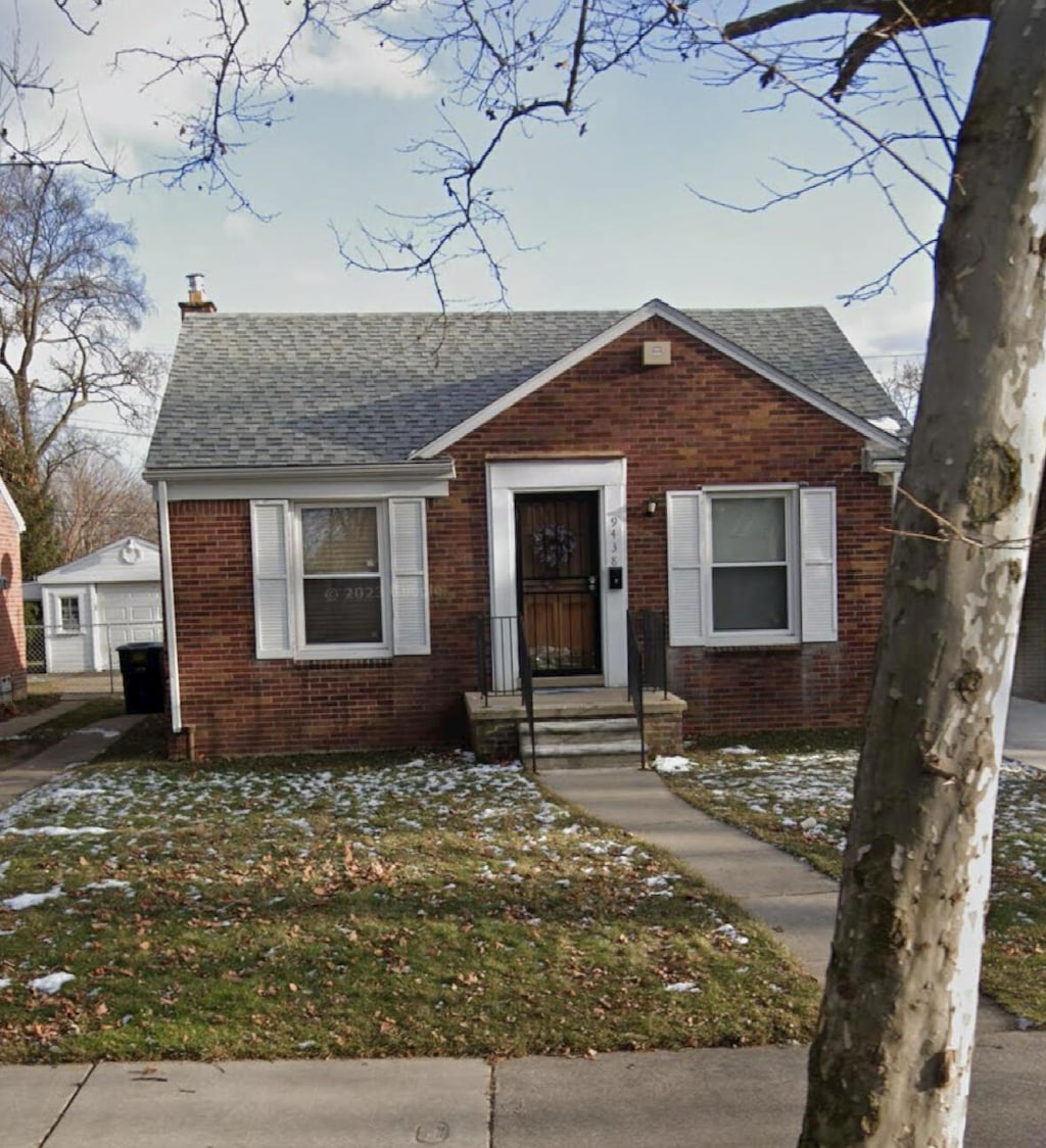 9438 Camley St, Detroit, MI 48224 - bungalow with a chimney, brick siding, a shingled roof, and a detached garage