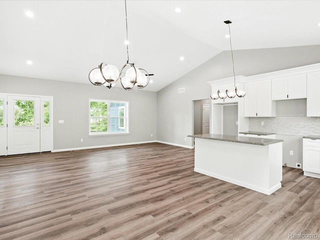 9711 Crawford, Columbus, MI 48063 - kitchen featuring a chandelier, white cabinets, stone counters, decorative backsplash, and high vaulted ceiling
