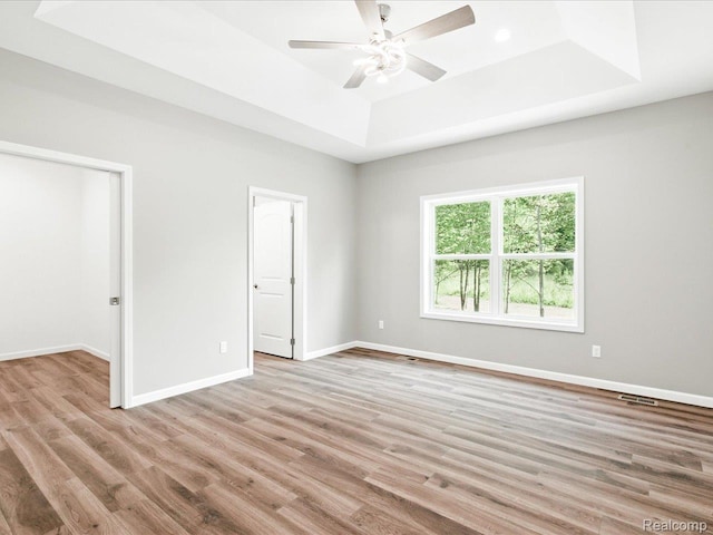 9711 Crawford, Columbus, MI 48063 - empty room featuring a raised ceiling, a ceiling fan, and wood finished floors