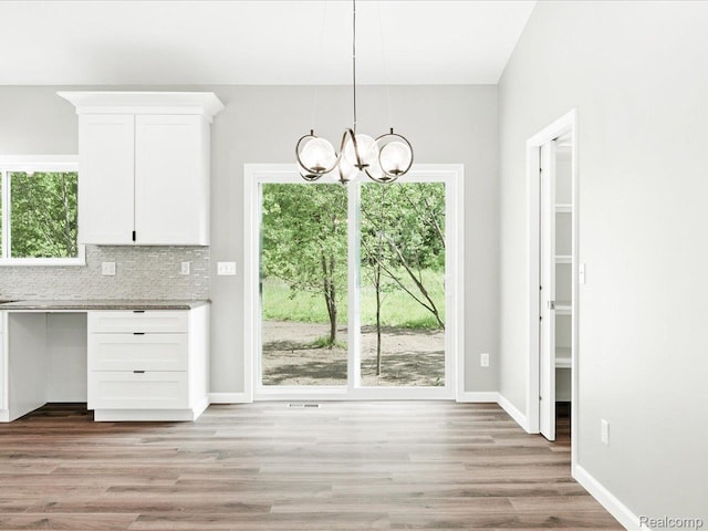 9711 Crawford, Columbus, MI 48063 - unfurnished dining area with a chandelier and light wood-style floors