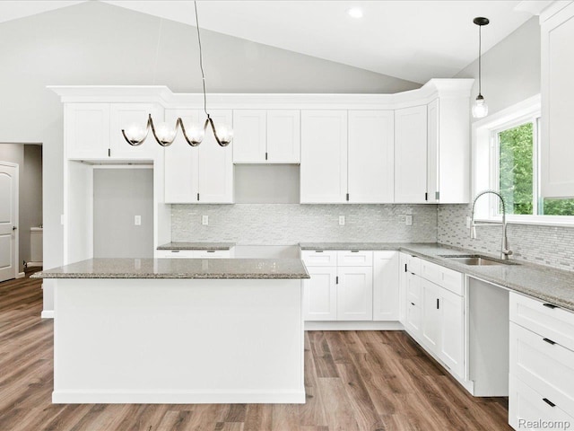 9711 Crawford, Columbus, MI 48063 - kitchen featuring lofted ceiling, light stone countertops, wood finished floors, white cabinets, and recessed lighting