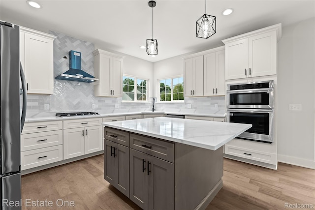 1180 Horseshoe Dr, South Lyon, MI 48178 - kitchen featuring wall chimney exhaust hood, stainless steel appliances, light wood-type flooring, white cabinets, and recessed lighting