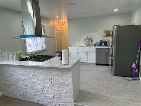 3550 Burns St, Inkster, MI 48141 - kitchen with appliances with stainless steel finishes, white cabinets, light wood-type flooring, wall chimney range hood, and light countertops