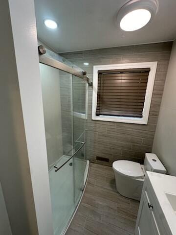 3550 Burns St, Inkster, MI 48141 - bathroom with vanity, a shower stall, and tile walls