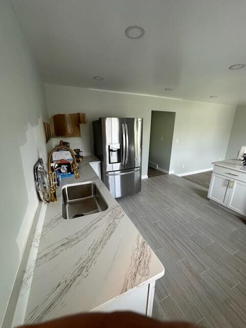 3550 Burns St, Inkster, MI 48141 - kitchen featuring stainless steel refrigerator with ice dispenser, wood finished floors, and white cabinets