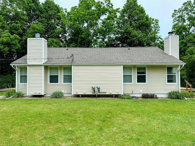 7841 Horseshoe Creek Ct, Whitmore Lake, MI 48189 - back of house with a chimney, a yard, and roof with shingles