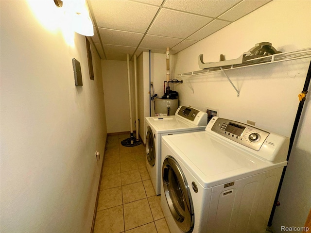 7841 Horseshoe Creek Ct, Whitmore Lake, MI 48189 - laundry room with washing machine and dryer, light tile patterned flooring, and electric water heater