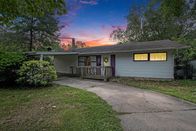 1538 Sheridan Ave, Niles, MI 49120 - view of front of home with concrete driveway, a carport, and a front lawn
