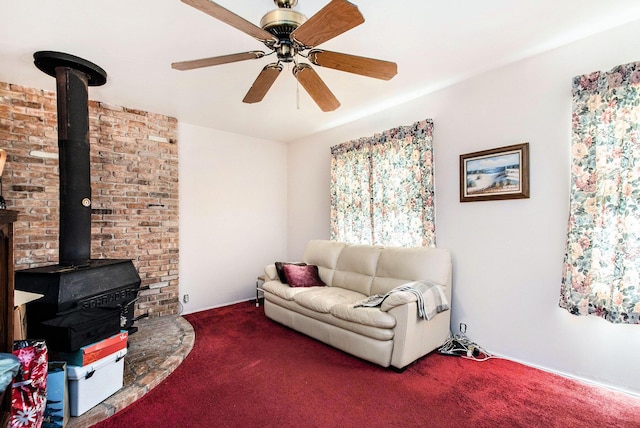 1538 Sheridan Ave, Niles, MI 49120 - living room featuring carpet floors, ceiling fan, and a wood stove