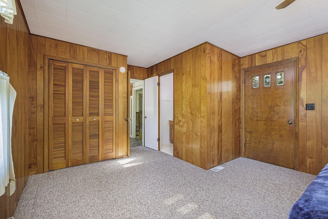 1507 Annie Ave NW, Grand Rapids, MI 49504 - carpeted bedroom featuring wood walls and a closet