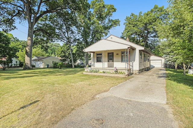 1507 Annie Ave NW, Grand Rapids, MI 49504 - shotgun-style home featuring a porch, an outdoor structure, a front yard, and a garage