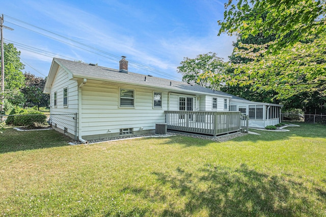 1136 3 Mile Rd NW, Grand Rapids, MI 49544 - back of house with a chimney, a wooden deck, and a sunroom