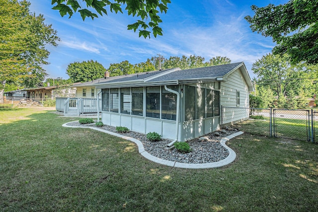 1136 3 Mile Rd NW, Grand Rapids, MI 49544 - back of property featuring a gate, a sunroom, and a shingled roof