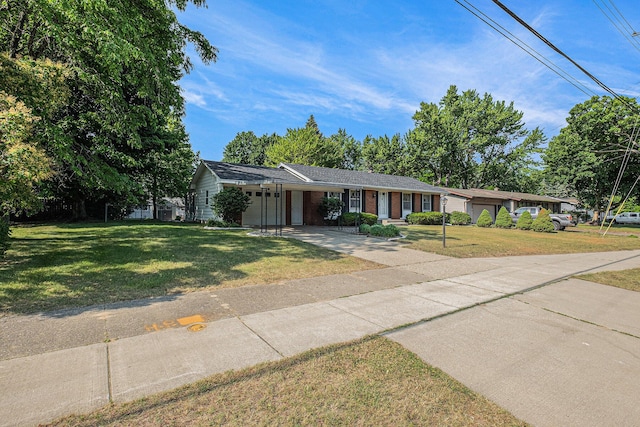 1136 3 Mile Rd NW, Grand Rapids, MI 49544 - ranch-style house with driveway, a front lawn, an attached carport, and brick siding