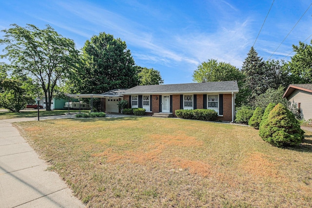 1136 3 Mile Rd NW, Grand Rapids, MI 49544 - ranch-style home with a garage, concrete driveway, a front yard, and brick siding