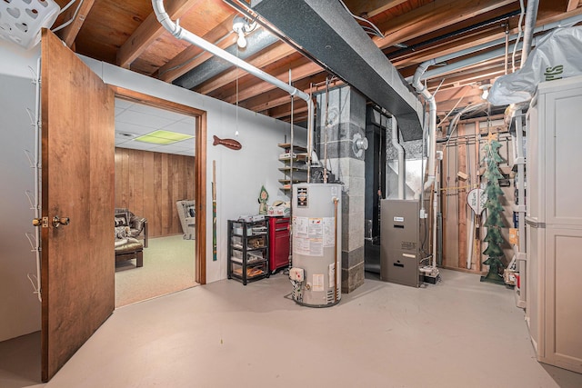 1136 3 Mile Rd NW, Grand Rapids, MI 49544 - unfinished basement with water heater, heating unit, and wooden walls