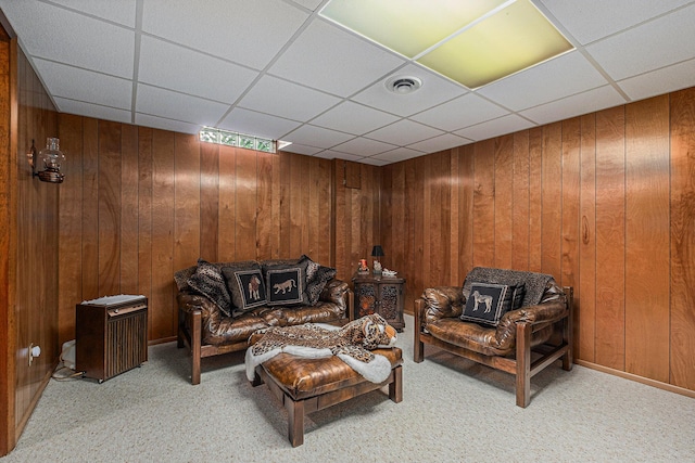 1136 3 Mile Rd NW, Grand Rapids, MI 49544 - carpeted living room featuring a paneled ceiling and wood walls
