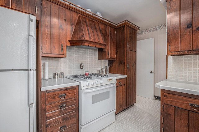 1136 3 Mile Rd NW, Grand Rapids, MI 49544 - kitchen featuring white appliances, custom range hood, decorative backsplash, and light countertops