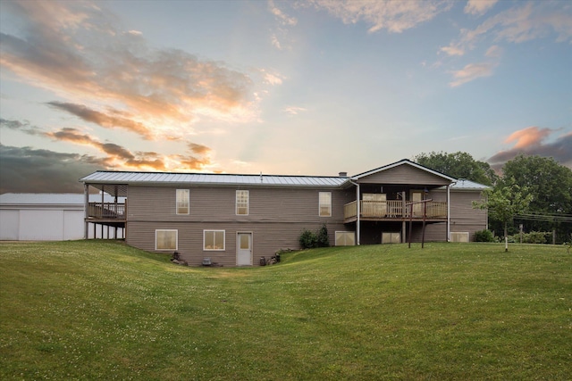 21576 220th Ave, Tustin, MI 49688 - back of house with a yard, a metal roof, a standing seam roof, and a deck