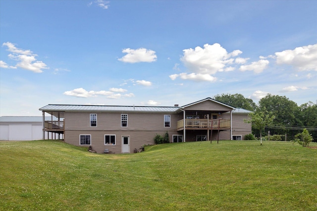 21576 220th Ave, Tustin, MI 49688 - back of house with a yard, a standing seam roof, a deck, and a metal roof