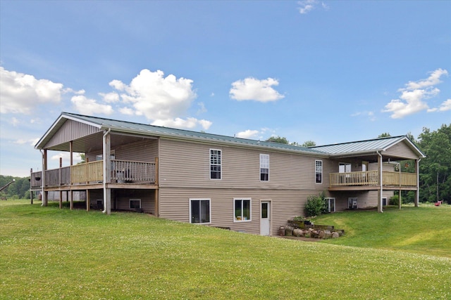 21576 220th Ave, Tustin, MI 49688 - back of house with a lawn, a metal roof, a standing seam roof, and a wooden deck