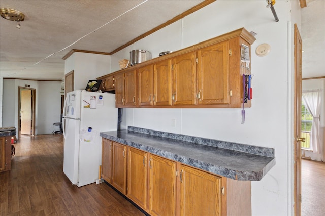 21576 220th Ave, Tustin, MI 49688 - kitchen featuring freestanding refrigerator, dark countertops, brown cabinets, crown molding, and a textured ceiling