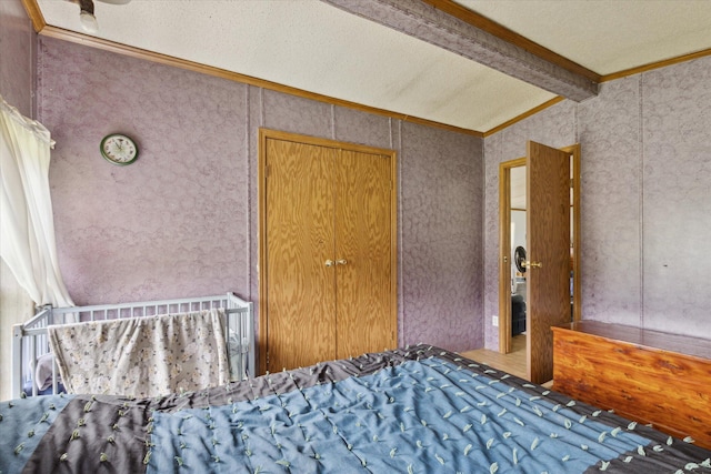 21576 220th Ave, Tustin, MI 49688 - unfurnished bedroom featuring ornamental molding, carpet flooring, wallpapered walls, and a textured ceiling