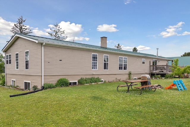 21576 220th Ave, Tustin, MI 49688 - rear view of house with a yard, a chimney, a metal roof, and a deck