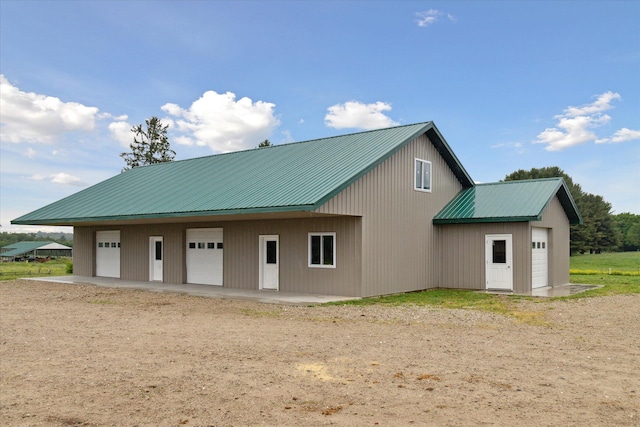 21576 220th Ave, Tustin, MI 49688 - exterior space featuring a garage and a metal roof