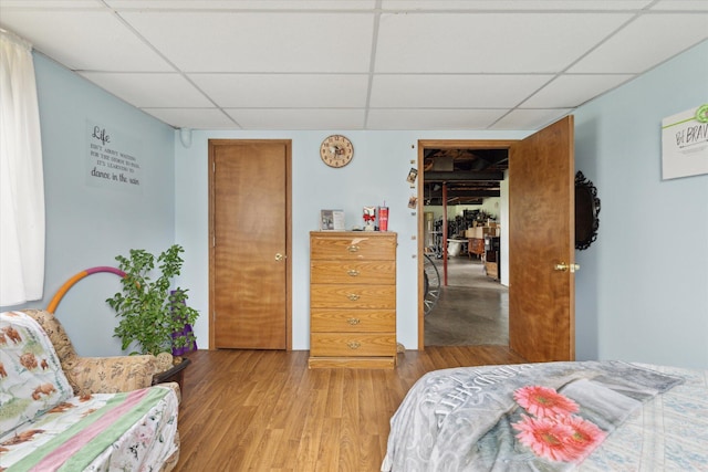 21576 220th Ave, Tustin, MI 49688 - bedroom featuring a drop ceiling and wood finished floors