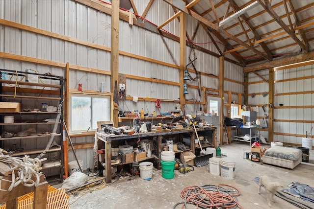 21576 220th Ave, Tustin, MI 49688 - garage featuring metal wall and a workshop area