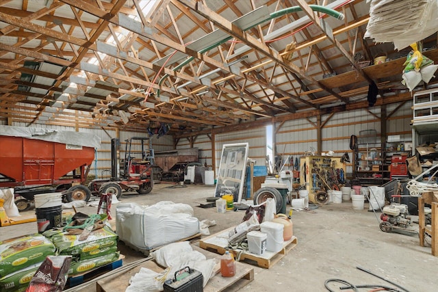 21576 220th Ave, Tustin, MI 49688 - garage with a workshop area and metal wall