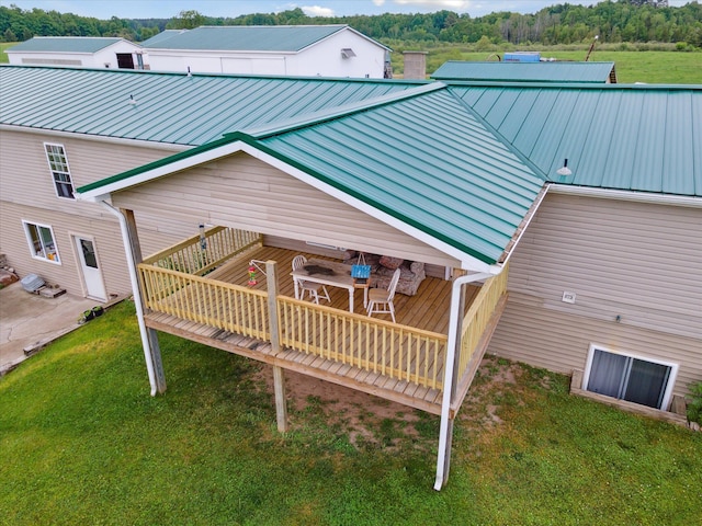 21576 220th Ave, Tustin, MI 49688 - back of property featuring a metal roof, a deck, and a yard