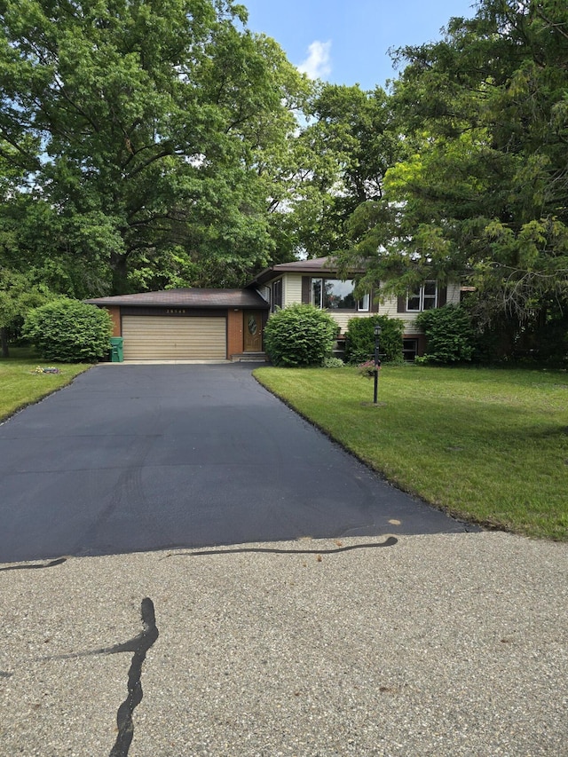 28548 Fairlane Dr, Dowagiac, MI 49047 - view of front of property featuring a front lawn, asphalt driveway, and an attached garage