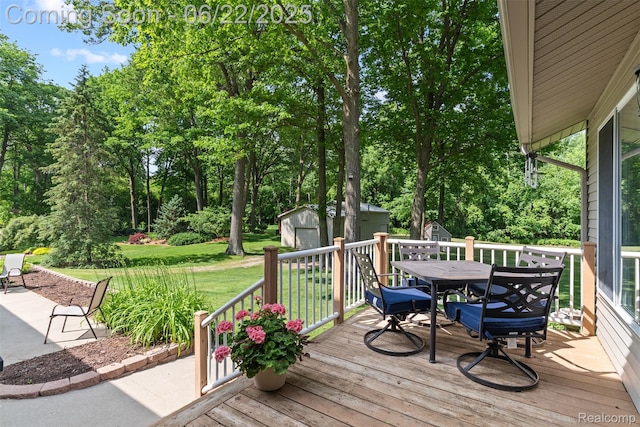 13256 Pine Valley Dr, Clio, MI 48420 - wooden terrace with a shed, outdoor dining area, a yard, and view of scattered trees