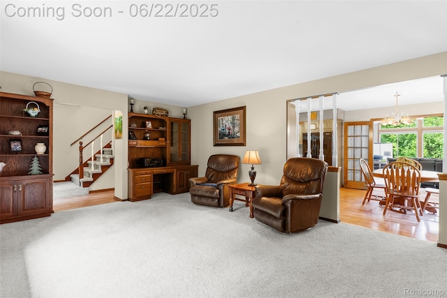 13256 Pine Valley Dr, Clio, MI 48420 - carpeted living room featuring stairway and a chandelier
