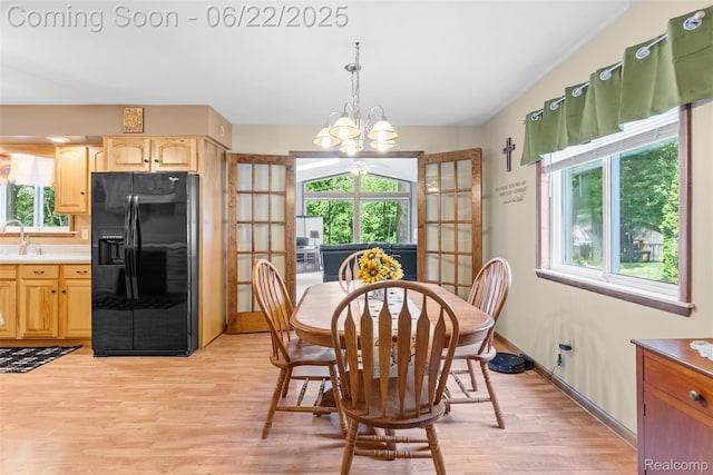 13256 Pine Valley Dr, Clio, MI 48420 - dining area with healthy amount of natural light, light wood-style flooring, and a chandelier