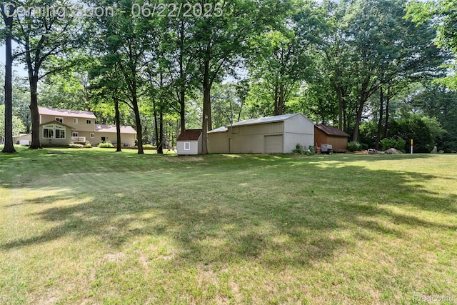 13256 Pine Valley Dr, Clio, MI 48420 - view of grassy yard featuring an outbuilding, view of wooded area, and a pole building