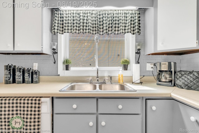 727 Minnie St, Port Huron, MI 48060 - kitchen with tasteful backsplash, light countertops, and white cabinets
