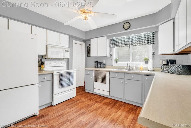 727 Minnie St, Port Huron, MI 48060 - kitchen featuring white appliances, a ceiling fan, decorative backsplash, light wood-style flooring, and light countertops