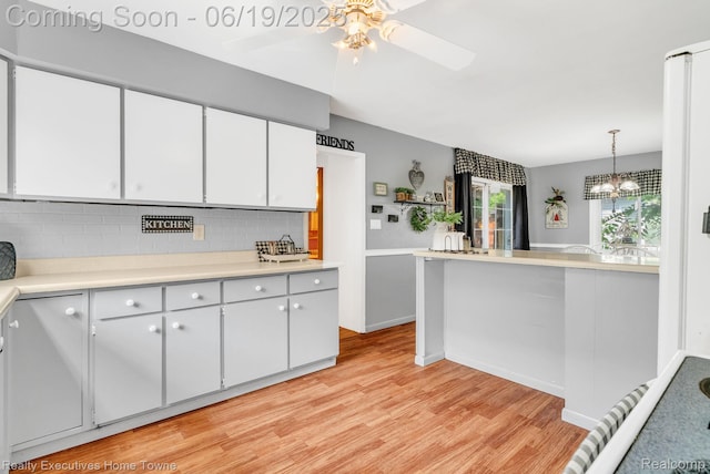 727 Minnie St, Port Huron, MI 48060 - kitchen with light wood-style floors, light countertops, tasteful backsplash, and a ceiling fan