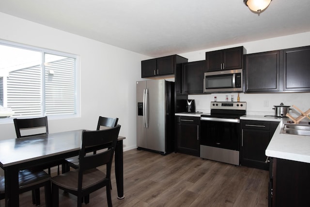 1633 Tea Pond Ct, Vicksburg, MI 49097 - kitchen featuring appliances with stainless steel finishes, light countertops, and dark wood-style floors