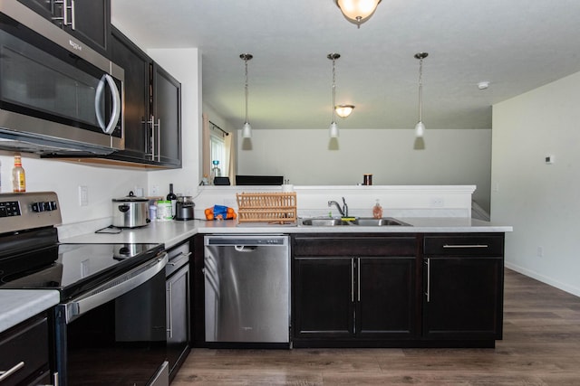 1633 Tea Pond Ct, Vicksburg, MI 49097 - kitchen featuring stainless steel appliances, a peninsula, light countertops, and wood finished floors