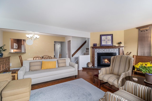 2519 Meade Ct, Ann Arbor, MI 48105 - living room featuring a chandelier, a tile fireplace, wood finished floors, and stairs