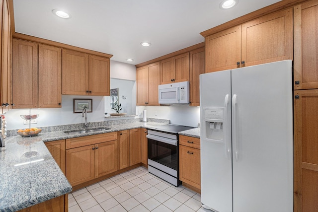 2519 Meade Ct, Ann Arbor, MI 48105 - kitchen with white appliances, brown cabinets, light tile patterned flooring, recessed lighting, and light stone countertops